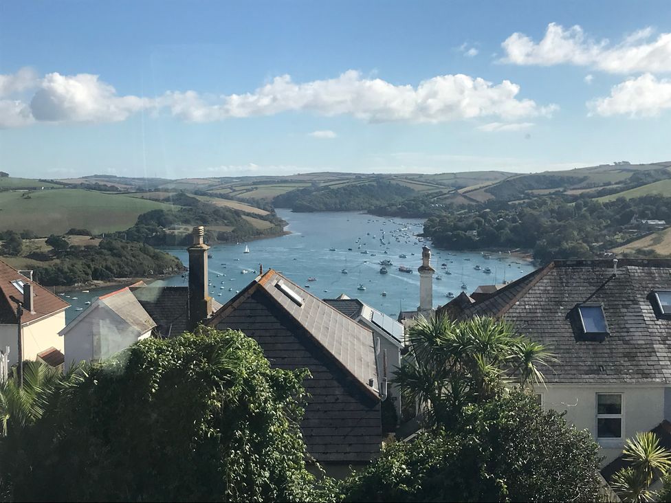 A view of boats on water surrounded by hills and houses at Firm Anchor in Salcombe