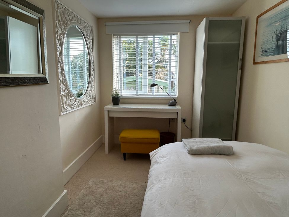 A bedroom with a bed and desk at Firm Anchor in Salcombe