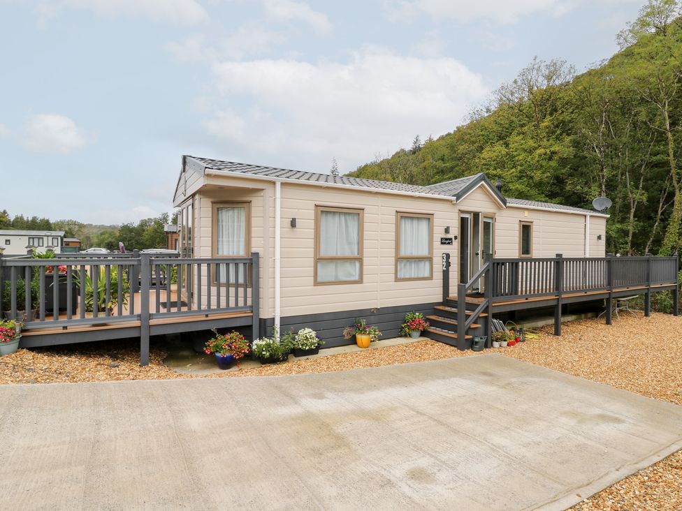 A mobile home with a deck and planters at The Haven in 