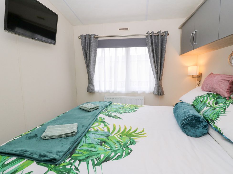 A bedroom with a bed and television at The Haven