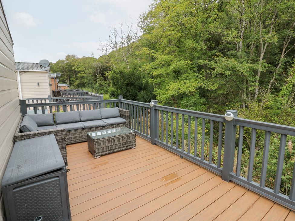 A deck with a sofa and coffee table at The Haven