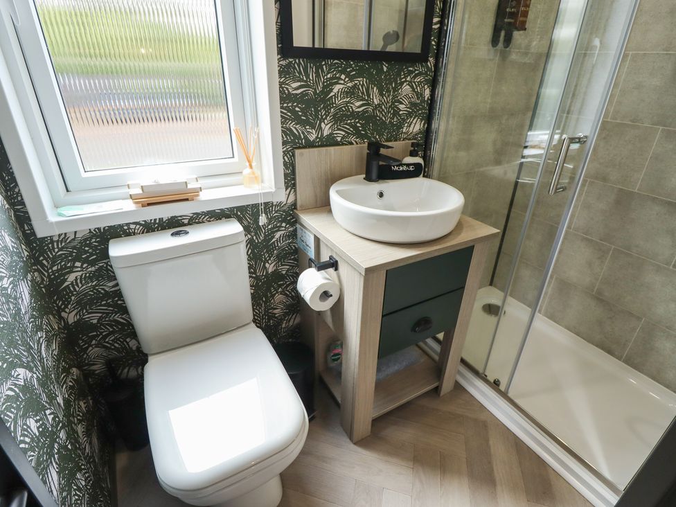 A bathroom with a shower and sink at Heather William Lodge near Woodhall Spa