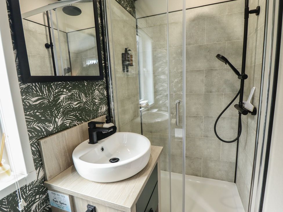 A bathroom with a sink and shower at Heather William Lodge near Woodhall Spa