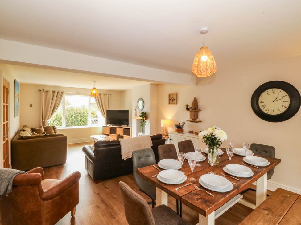 A dining room with a table set for meals at Ty Ni in Dyffryn Ardudwy