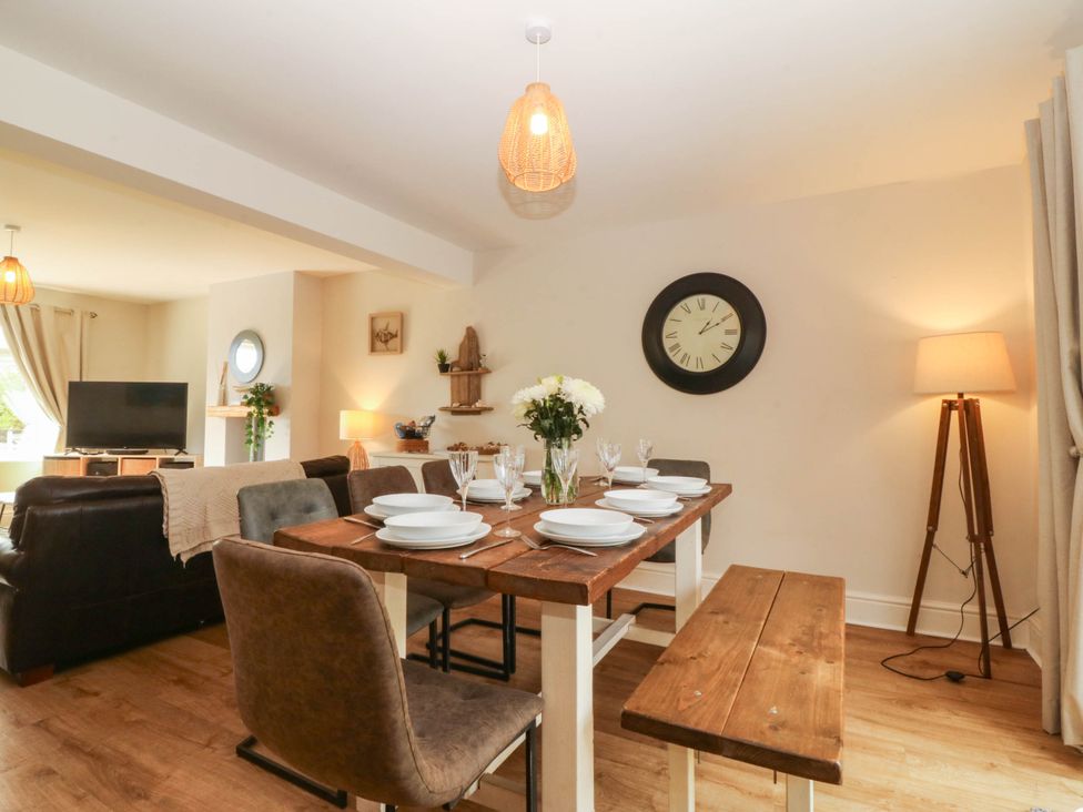 A dining room with a table set for dinner at Ty Ni Dyffryn Ardudwy