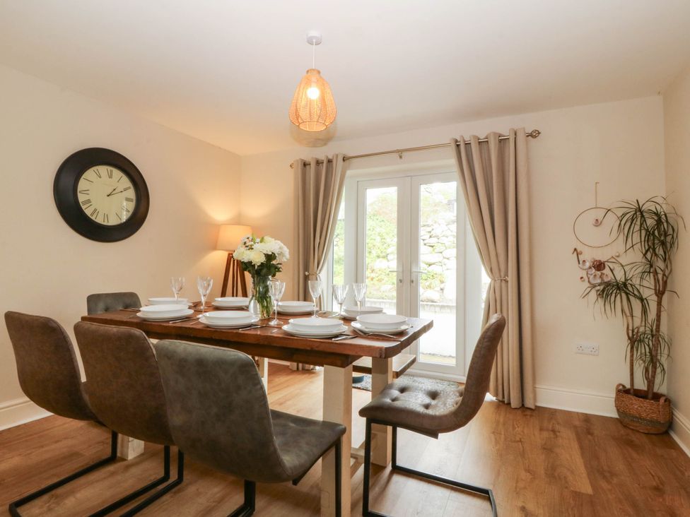 A dining room with a table set for dinner at Ty Ni in Dyffryn Ardudwy