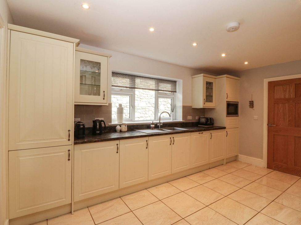 A kitchen with cabinets sink and countertop at Ty Ni in Dyffryn Ardudwy