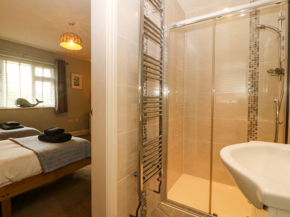 A bedroom with a shower and sink at Ty Ni Dyffryn Ardudwy