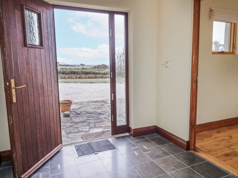 An entrance hall with a door and doormat at Cashelrehine Falcarrheh