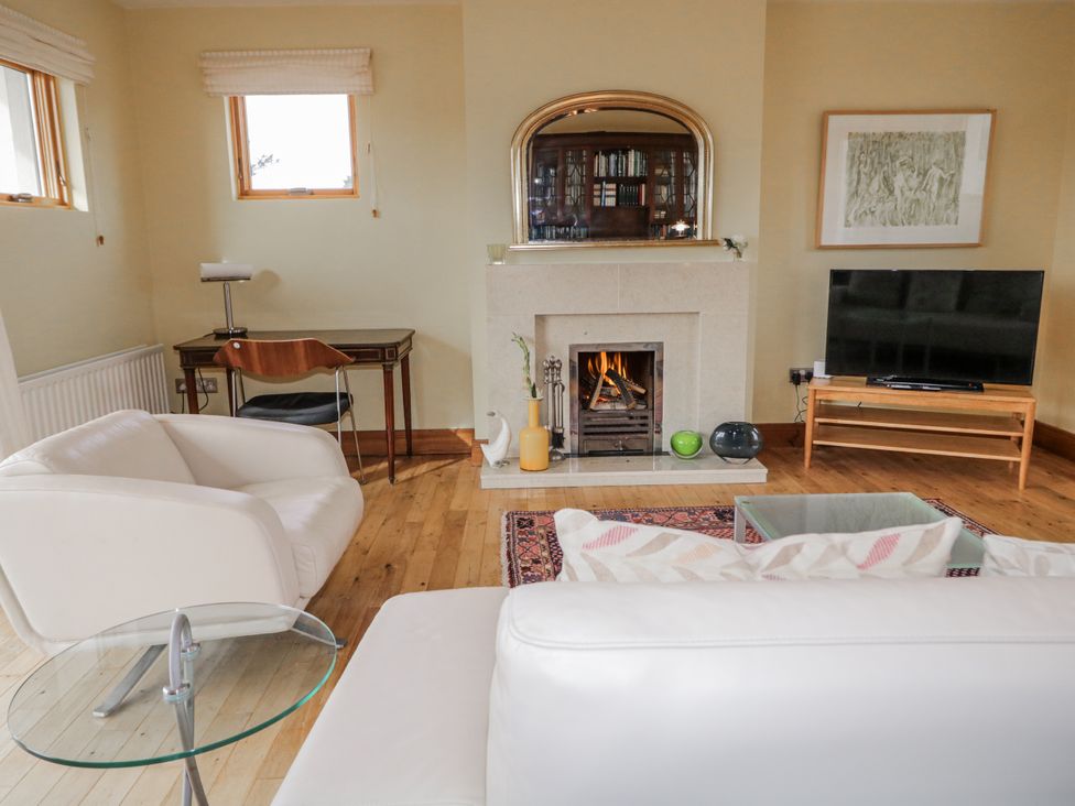 A living room with furniture and a fireplace at Cashelrehine in Falcarrheh