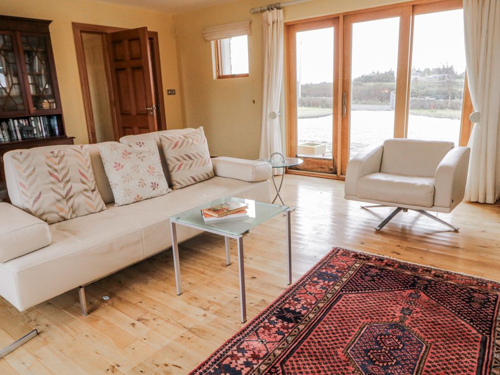 A living room with a sofa and coffee table at Cashelrehine Falcarrheh