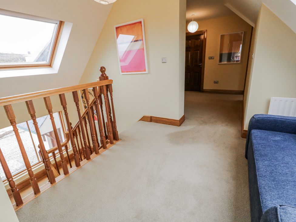 A hallway with stairs and a window at Cashelrehine in Falcarrheh