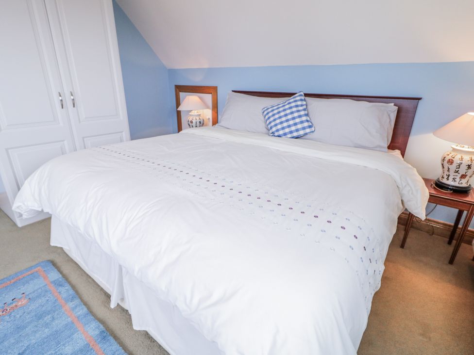 A bedroom with a bed and nightstand at Cashelrehine in Falcarrheh