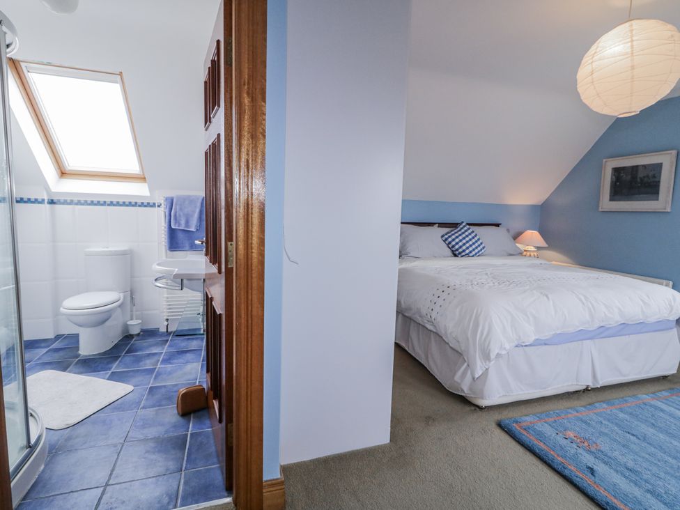 A bedroom with a bed and bathroom with a shower at Cashelrehine, Falcarrheh