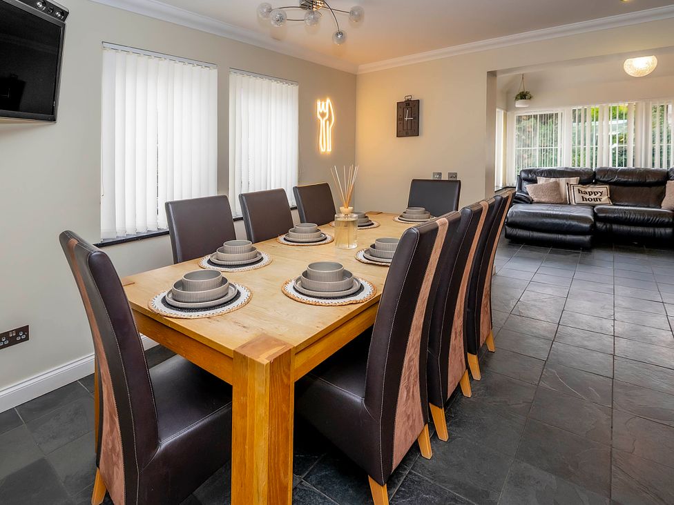 A dining room with a large table and chairs at Taighean Anndra in Killin