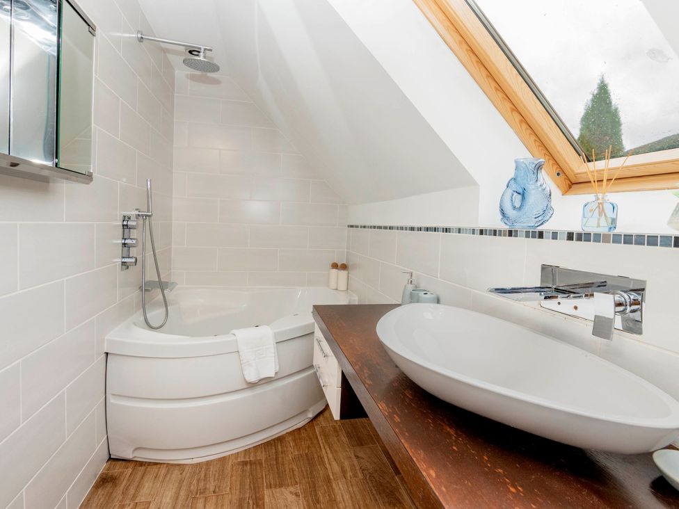 A bathroom with a bathtub and sink at Taighean Anndra in Killin