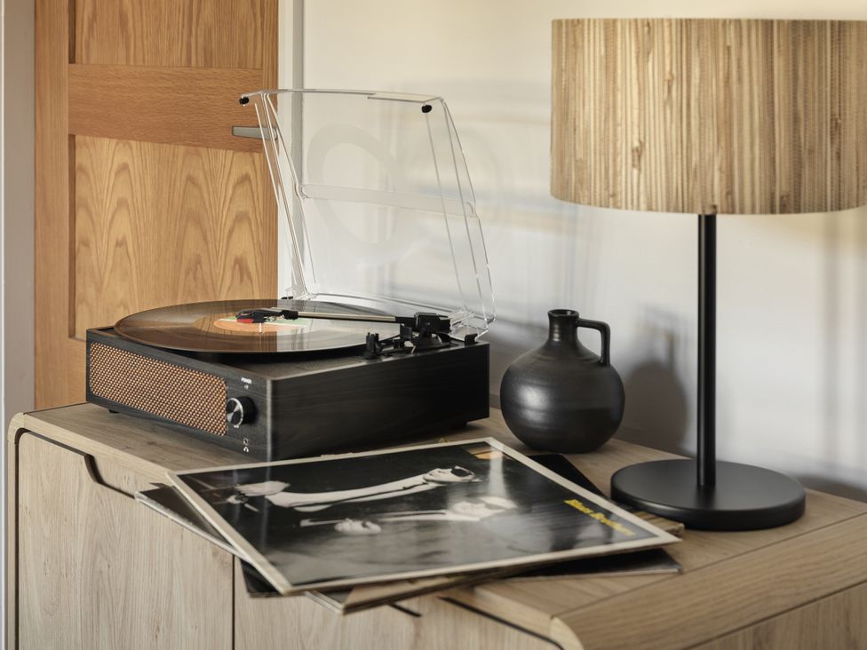 A turntable with a vinyl record on a storage unit at Rydal Apartment Ambleside