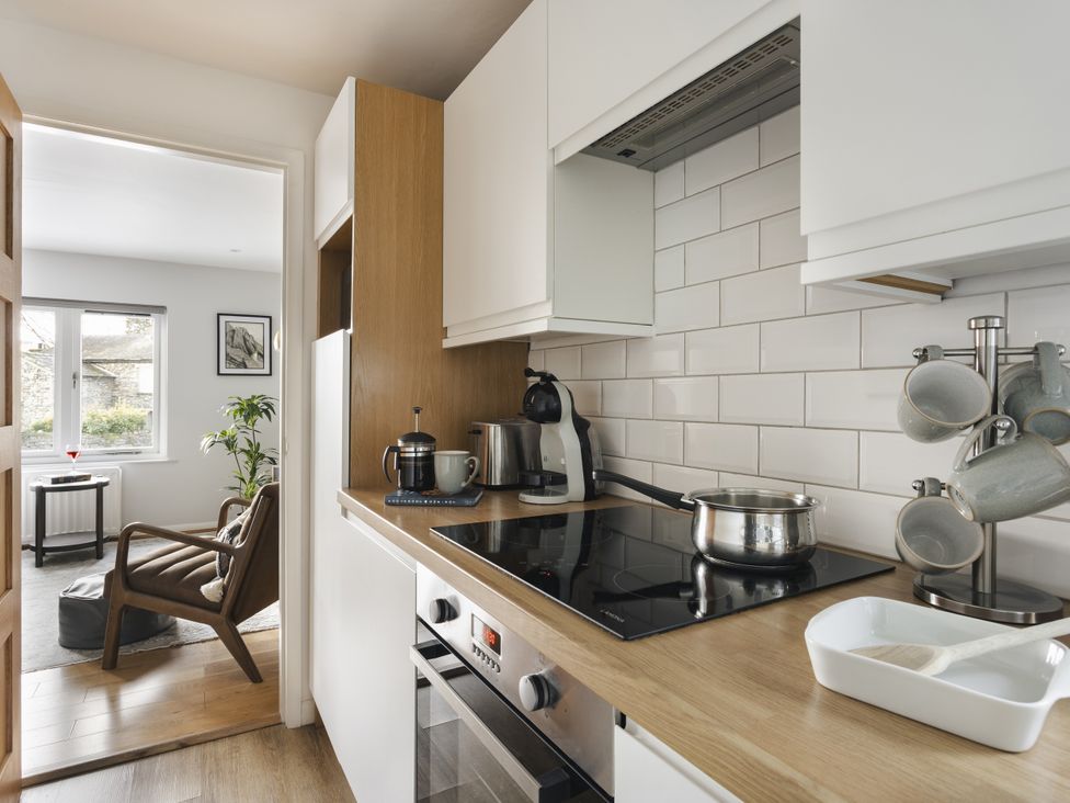 A kitchen with stove and coffee machine at Rydal Apartment Ambleside in Ambleside