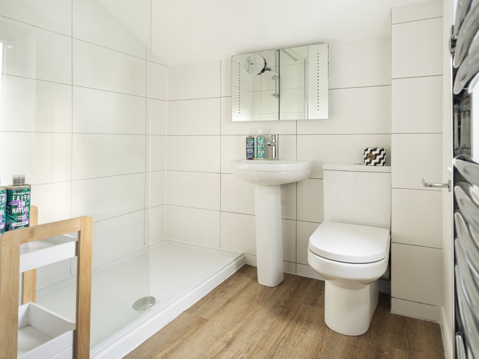 A bathroom with a shower, sink, and toilet at Rydal Apartment Ambleside in Ambleside