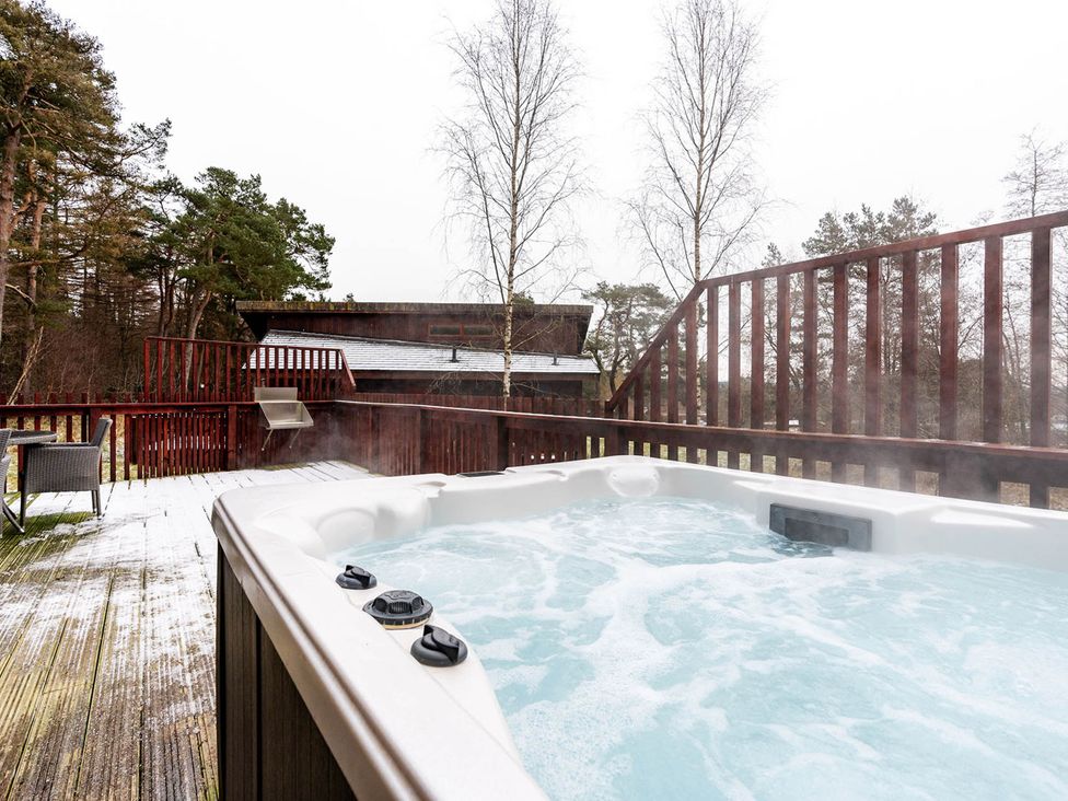 A hot tub on an outdoor deck at Deerpark Classic Silver Birch Deerpark Forest