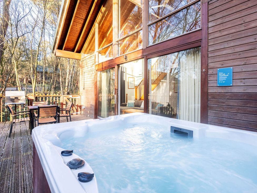 An outdoor area with a hot tub and seating at Deerpark Classic Silver Birch Deerpark Forest