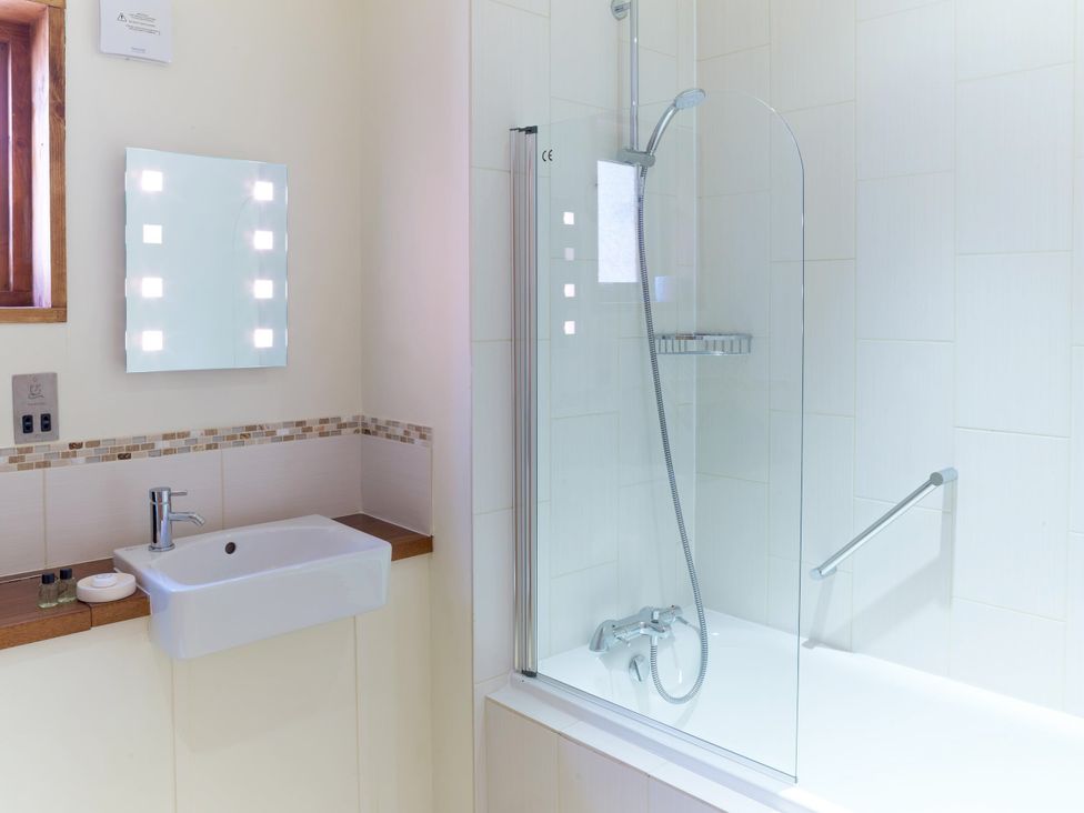 A bathroom with a sink and shower at Strathyre Golden Oak Lochside in Strathyre, Ben Ledi