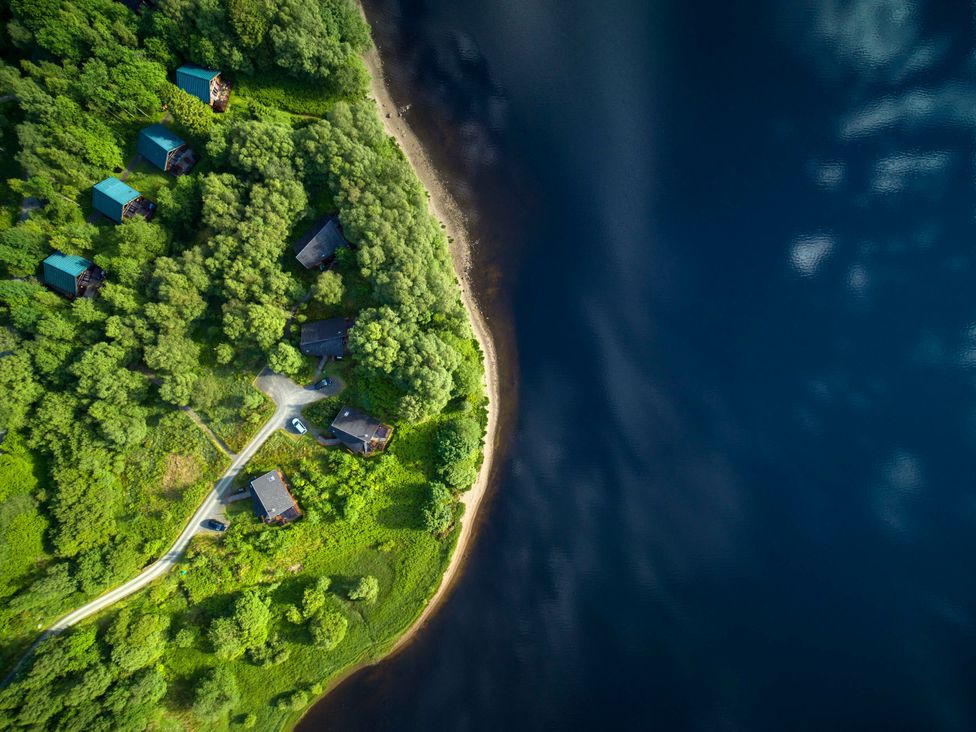 An aerial view of cabins near a lake at Strathyre Golden Oak Lochside Strathyre, Ben Ledi