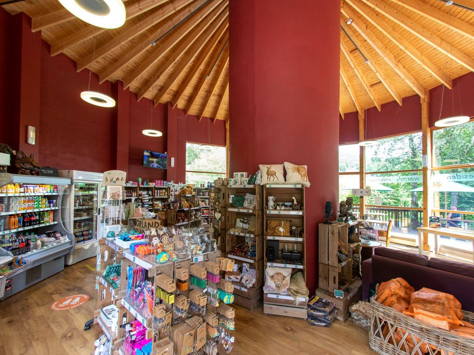 A shop interior with shelves and a refrigerator at Strathyre Golden Oak Lochside Strathyre, Ben Ledi