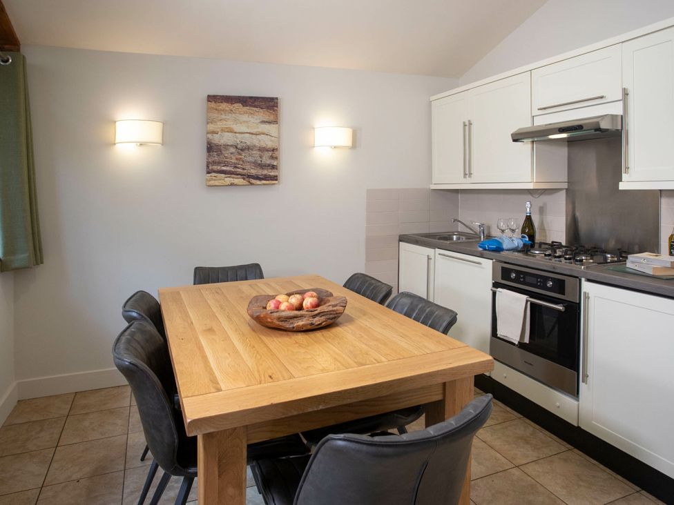 A kitchen with a dining table and chairs at Blackwood Forest Golden Oak in Blackwood Forest