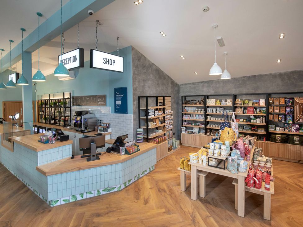 A shop interior with a reception desk and various products at Delamere Forest Golden Oak Hideaway Delamere Forest