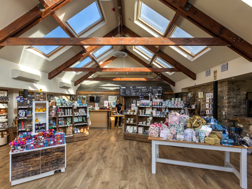 A retail store with shelves of products at Cropton Golden Oak in Cropton Forest