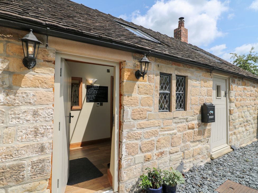 A doorway entrance with stone walls at 33 Main Road Higham Derbyshire