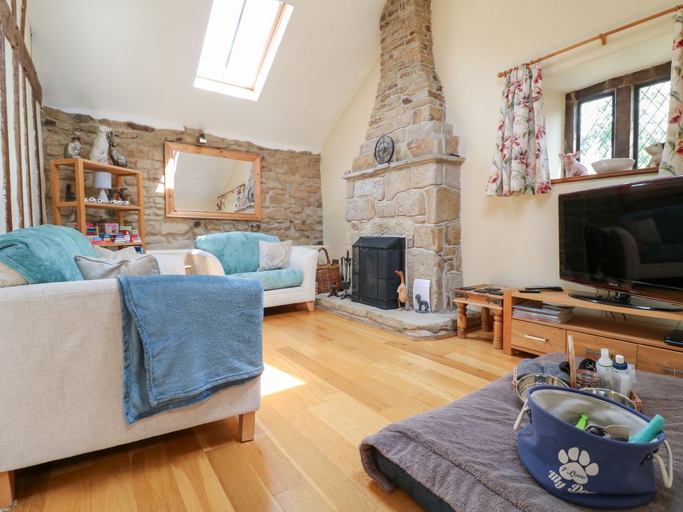 A living room with a fireplace and furniture at 33 Main Road in Higham Derbyshire