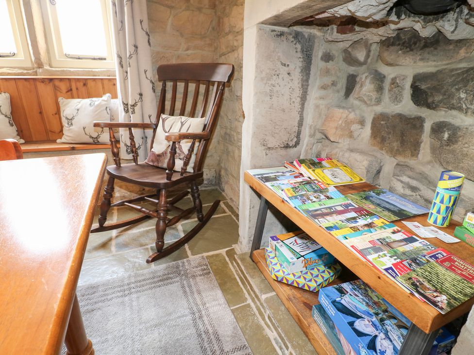 A snug with a rocking chair and brochures on a shelf at 33 Main Road in Higham Derbyshire