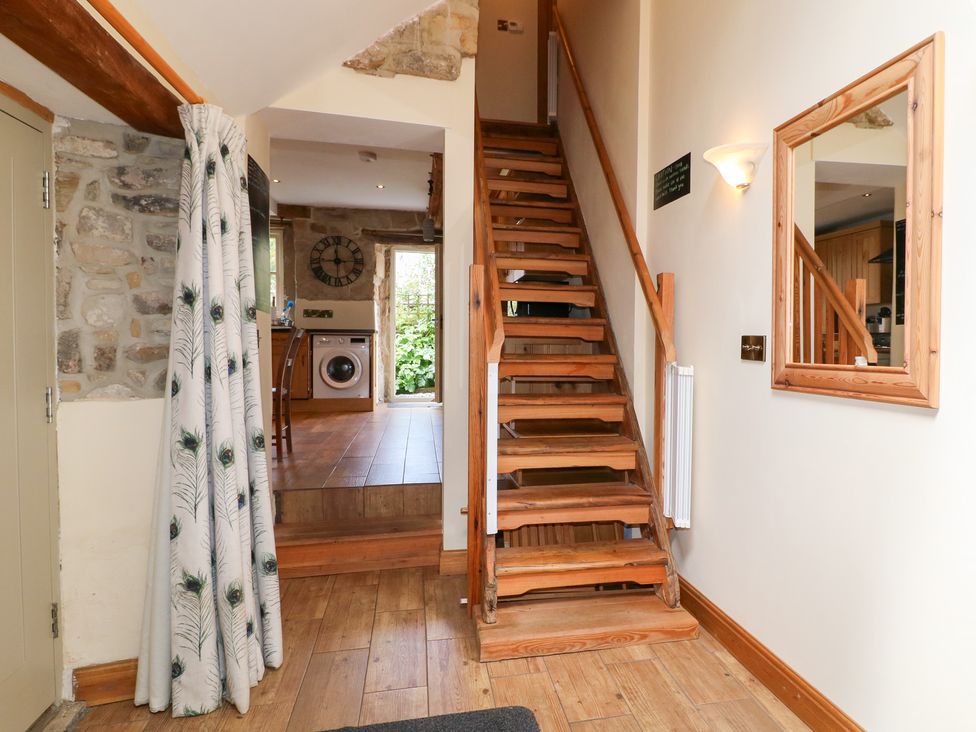 A hallway with stairs leading to upper floor at 33 Main Road Higham Derbyshire