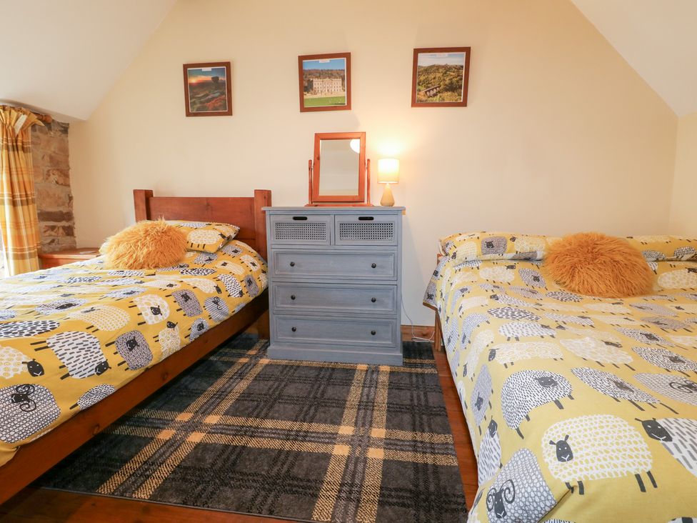 A bedroom with two beds and a dresser at 33 Main Road in Higham Derbyshire