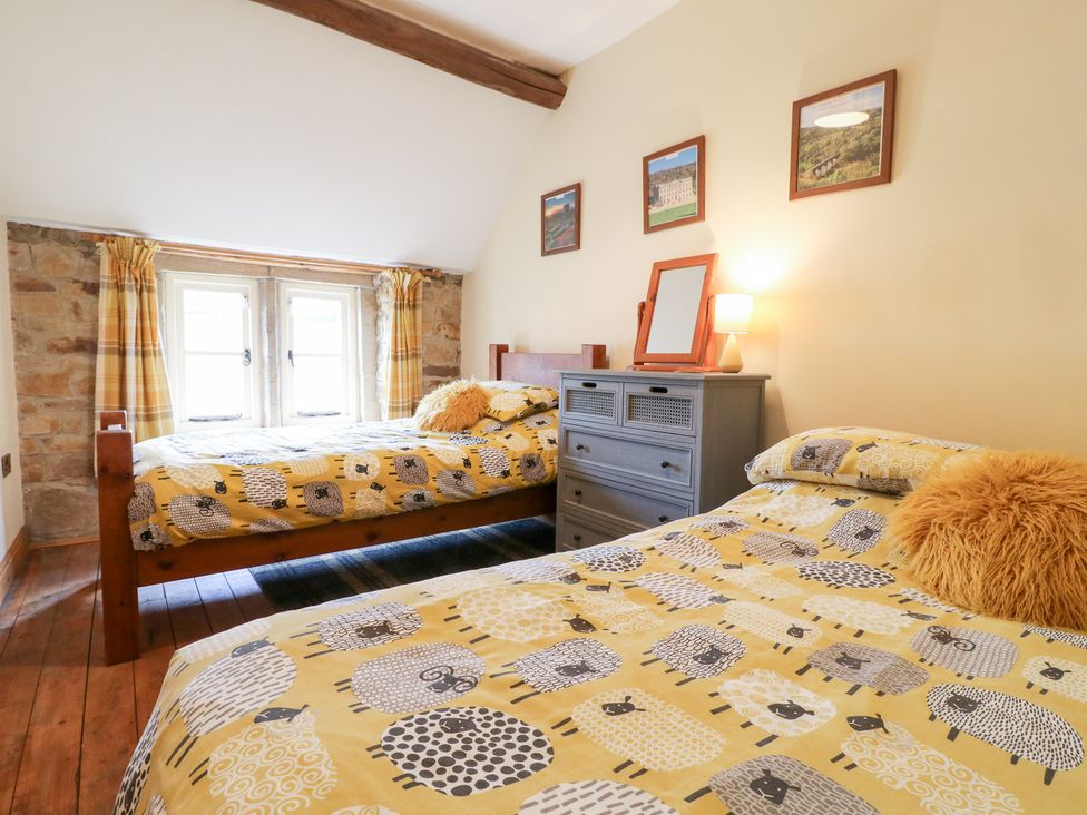 A bedroom with two beds and a dresser at 33 Main Road in Higham Derbyshire