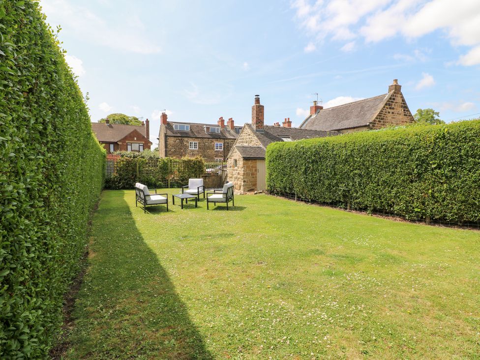 A garden with seating and hedge at 33 Main Road Higham Derbyshire