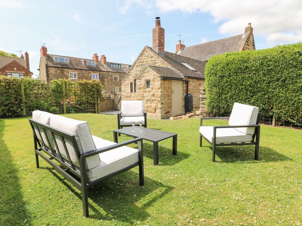 A garden with seating and a house at 33 Main Road in Higham Derbyshire