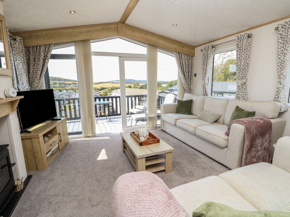 A living room with sofa and television at 31 Crosswinds in Bembridge
