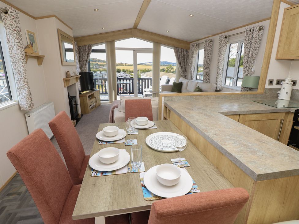 A dining area with a table set at 31 Crosswinds in Bembridge