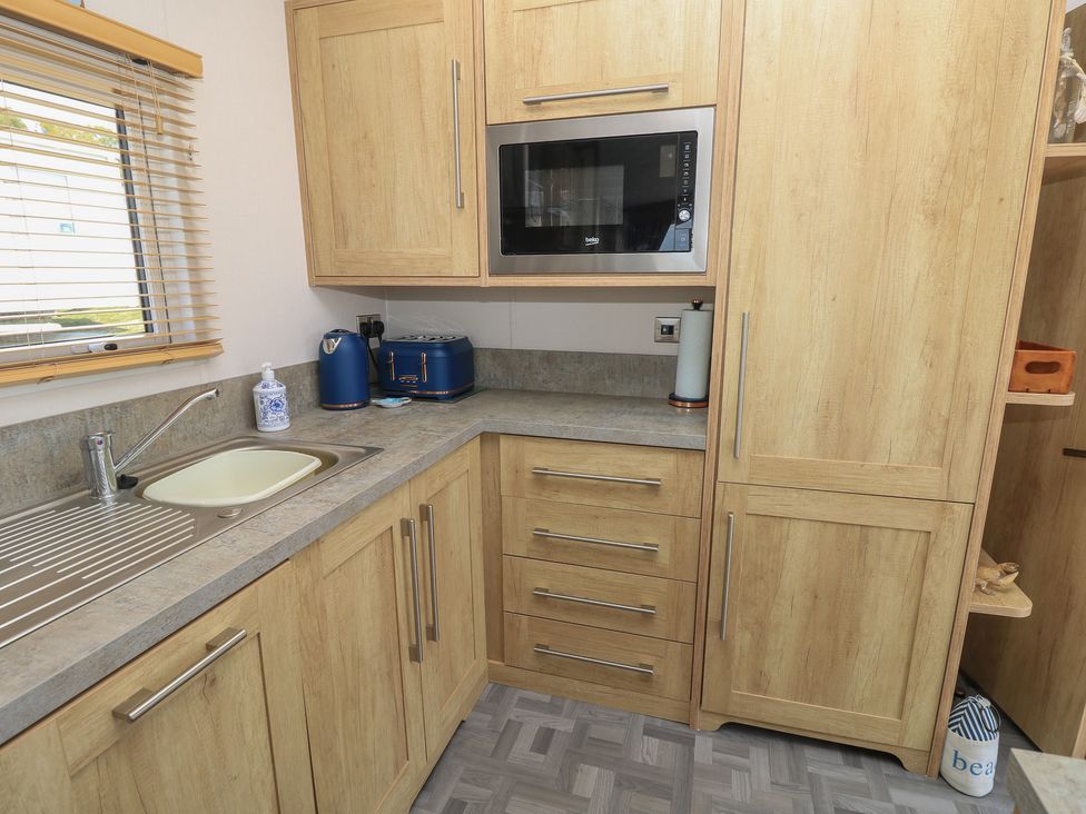 A kitchen with cabinets and a sink at 31 Crosswinds in Bembridge