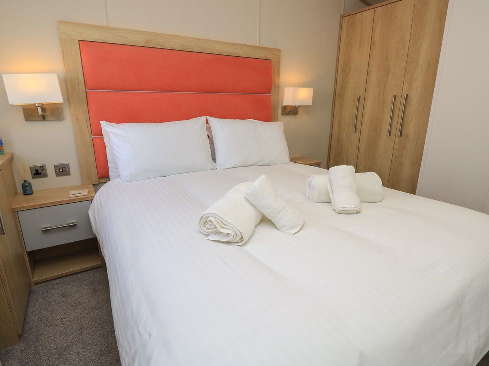 A bedroom with a bed and wardrobe at 31 Crosswinds Bembridge