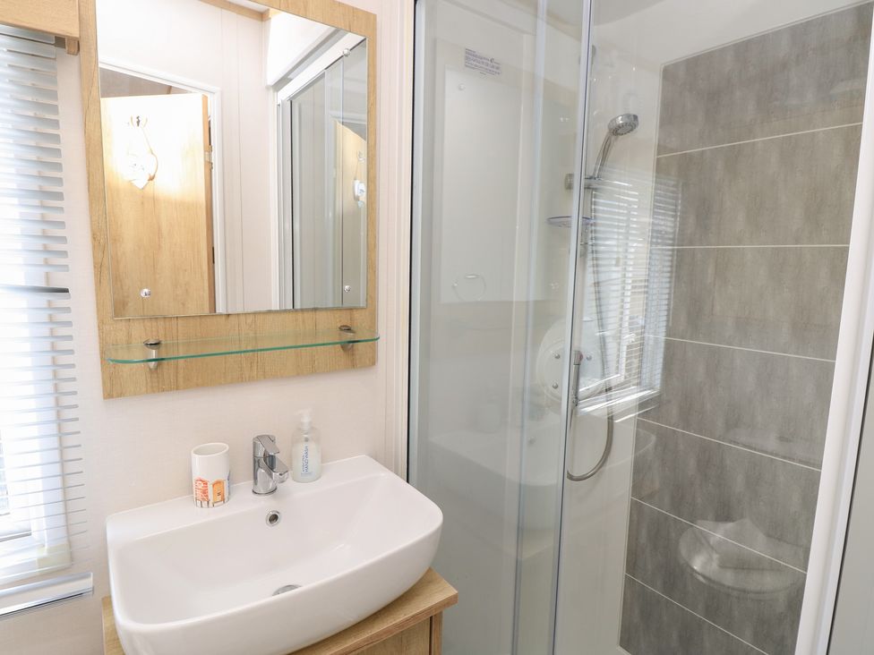 A bathroom with a sink and shower at 31 Crosswinds, Bembridge