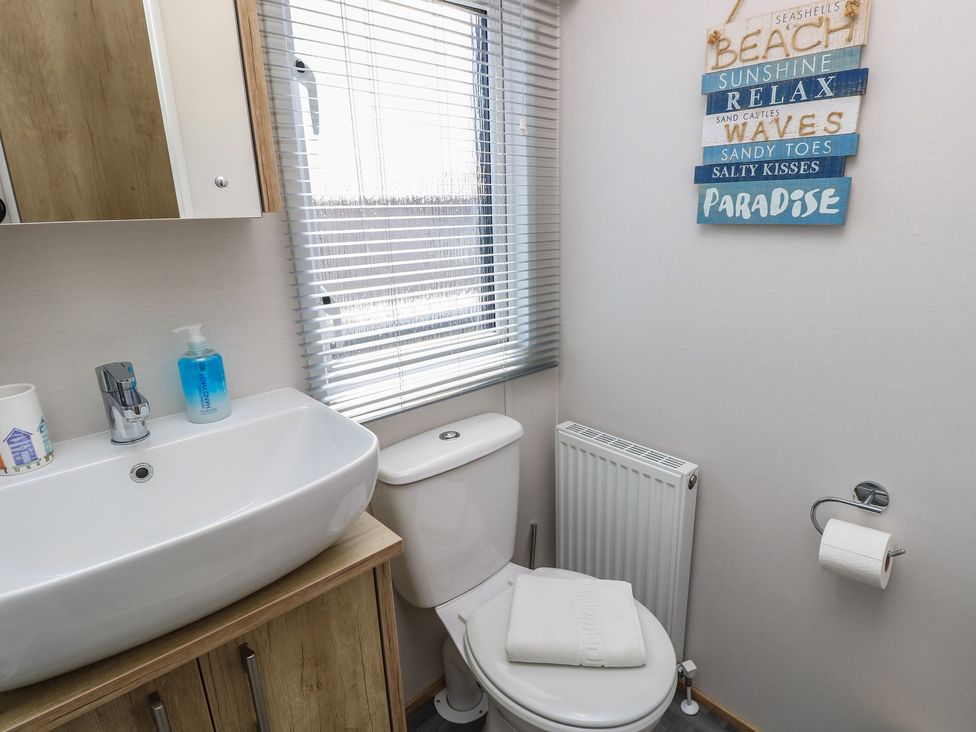 A bathroom with a sink and toilet at 31 Crosswinds in Bembridge
