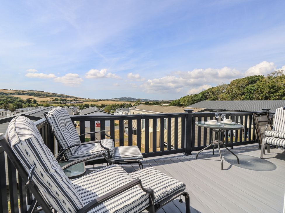 An outdoor seating area with chairs and a table at 31 Crosswinds in Bembridge