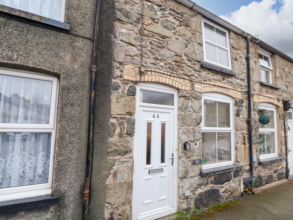 A stone house exterior with a front door and windows at Hill View in Bala