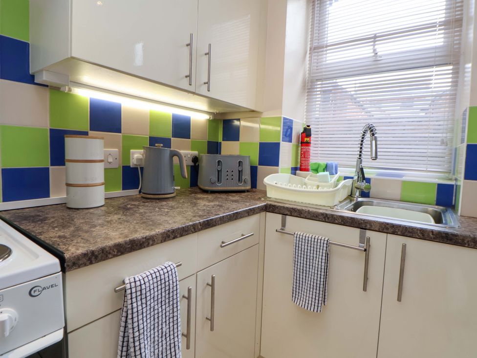 A kitchen with appliances and dish rack at Hill View in Bala