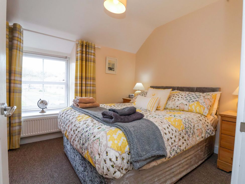 A bedroom with a bed and window at Hill View in Bala