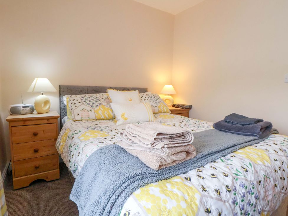A bedroom with a bed and nightstand at Hill View in Bala